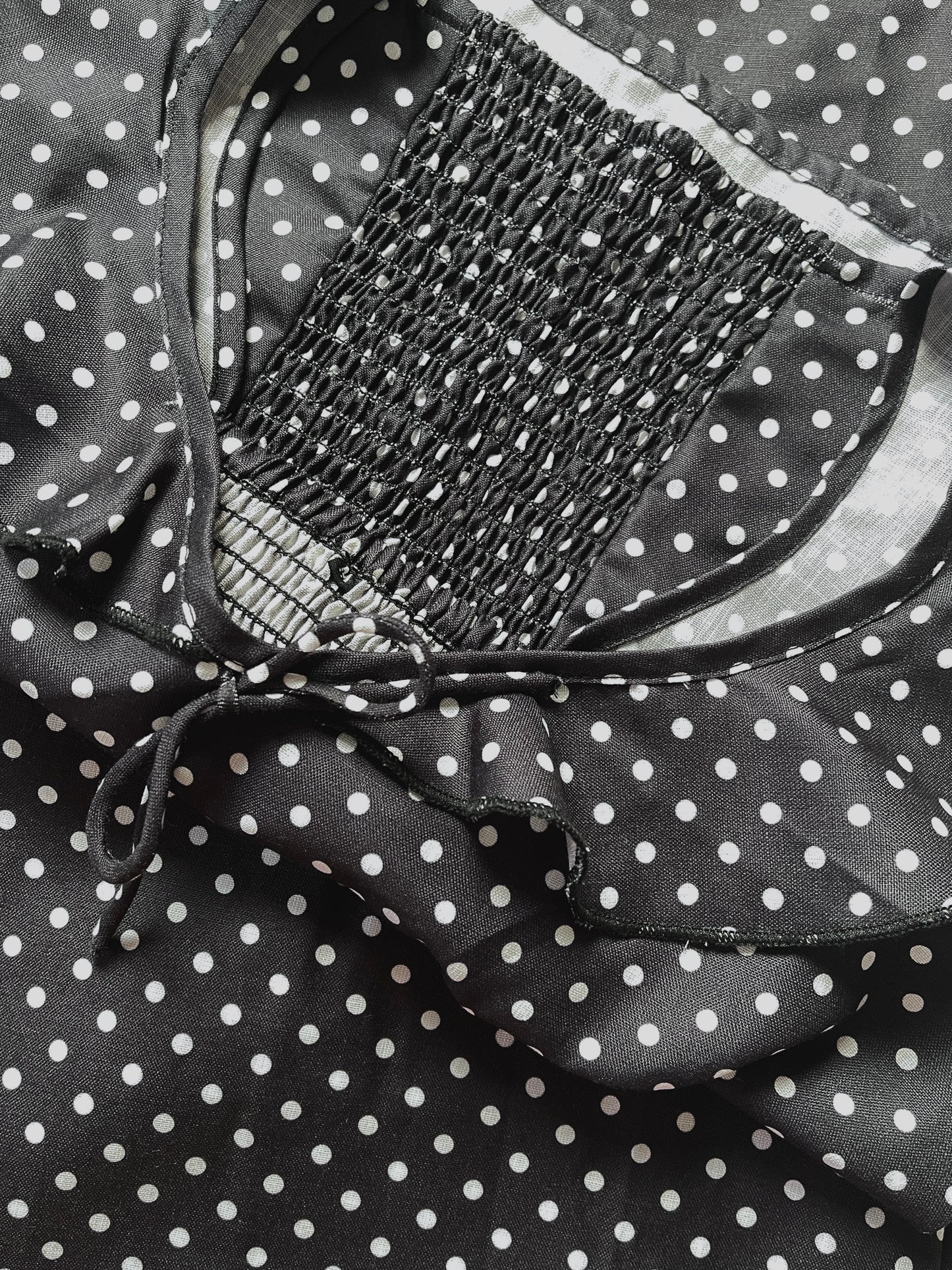 Mira Polka Dot Flounce Neck Top In Black